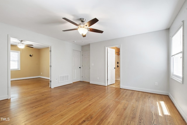 1005 Temple St, Raleigh, NC 27609 - empty room with a ceiling fan, light wood finished floors, and baseboards