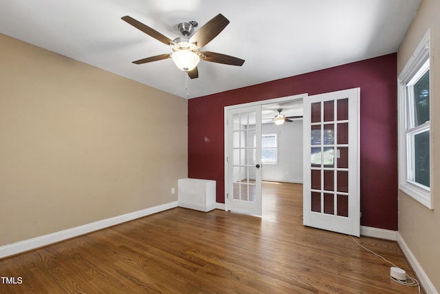 1005 Temple St, Raleigh, NC 27609 - empty room featuring french doors, wood finished floors, ceiling fan, and baseboards