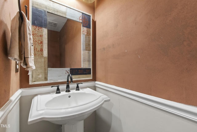 1005 Temple St, Raleigh, NC 27609 - bathroom with a sink and a wainscoted wall