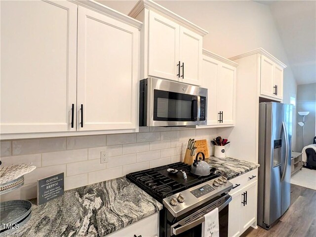 3904 Lundin Dr, Greensboro, NC 27407 - kitchen with appliances with stainless steel finishes, stone countertops, white cabinets, backsplash, and dark wood-style floors