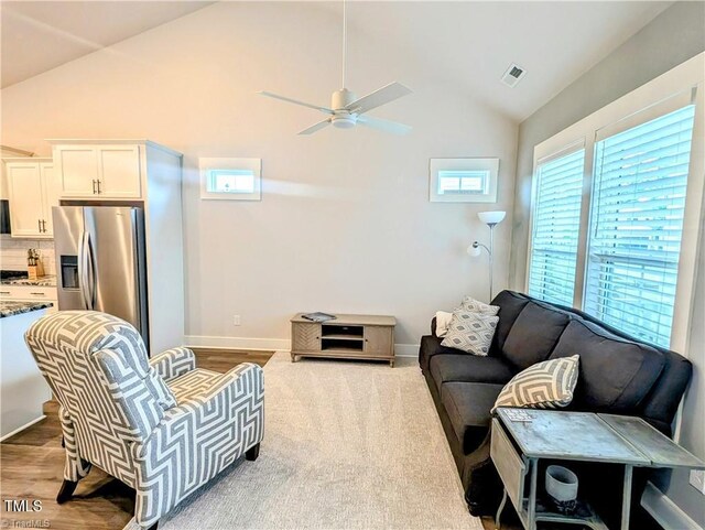 3904 Lundin Dr, Greensboro, NC 27407 - living room with a ceiling fan, baseboards, wood finished floors, and high vaulted ceiling