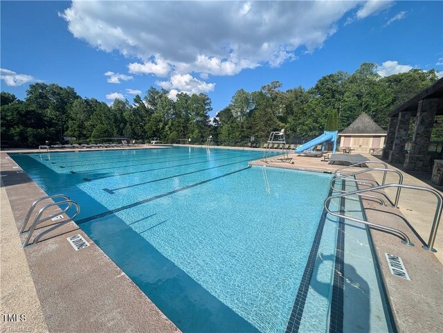 3904 Lundin Dr, Greensboro, NC 27407 - community pool featuring a water slide and a patio