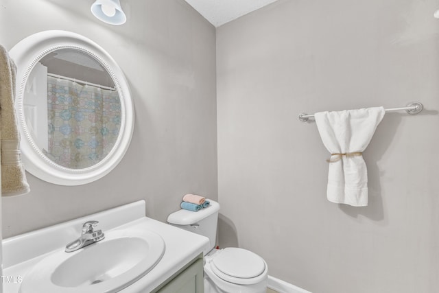 bathroom featuring vanity, toilet, and a shower with curtain