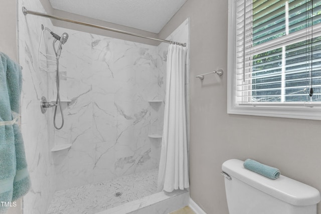 full bathroom with toilet, a marble finish shower, and a textured ceiling