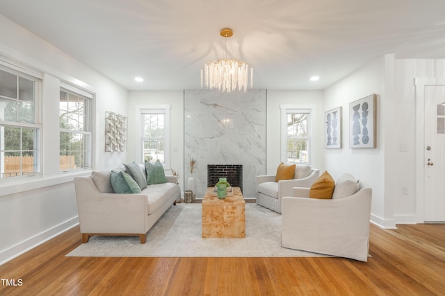 2515 W Club Blvd, Durham, NC 27705 - living room featuring wood finished floors, a chandelier, baseboards, a premium fireplace, and recessed lighting