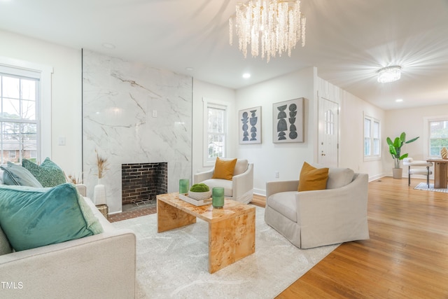 2515 W Club Blvd, Durham, NC 27705 - living area featuring wood finished floors, a chandelier, a fireplace, recessed lighting, and baseboards