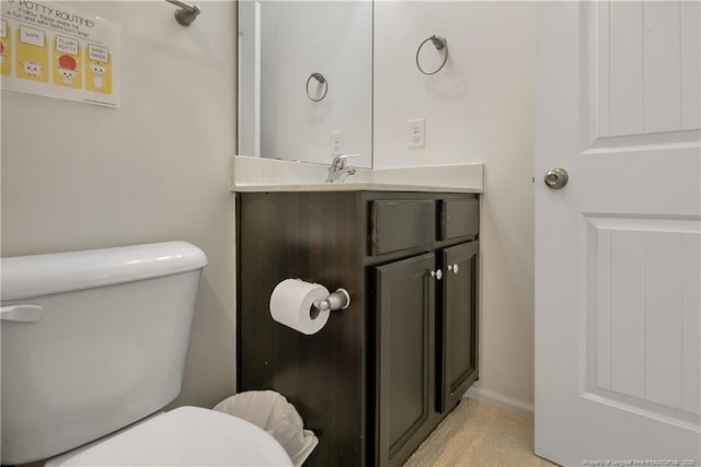 bathroom featuring toilet and vanity