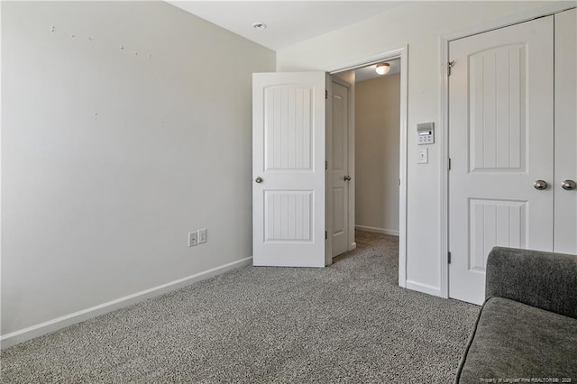 carpeted bedroom featuring baseboards