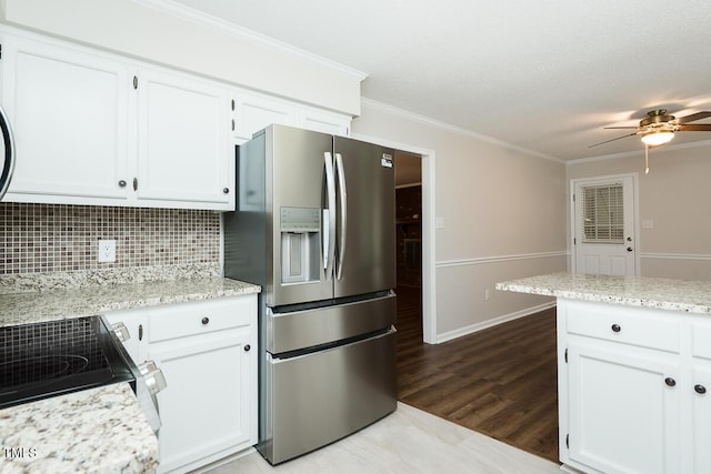 kitchen featuring stainless steel refrigerator with ice dispenser, a ceiling fan, white cabinets, range with electric cooktop, and crown molding
