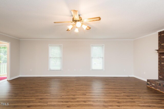 unfurnished living room featuring a brick fireplace, a ceiling fan, ornamental molding, dark wood-style flooring, and baseboards