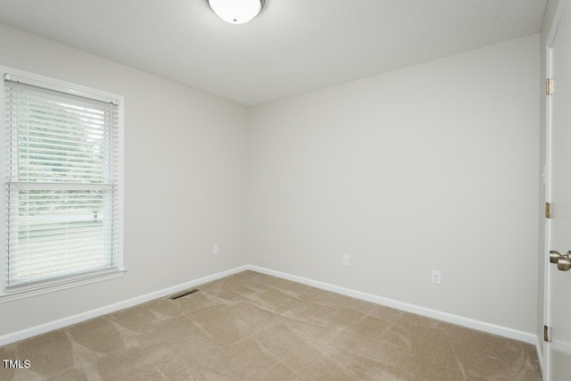 empty room with carpet and baseboards