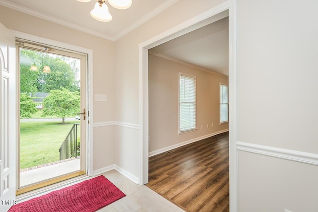 doorway featuring ornamental molding, a chandelier, baseboards, and tile patterned floors
