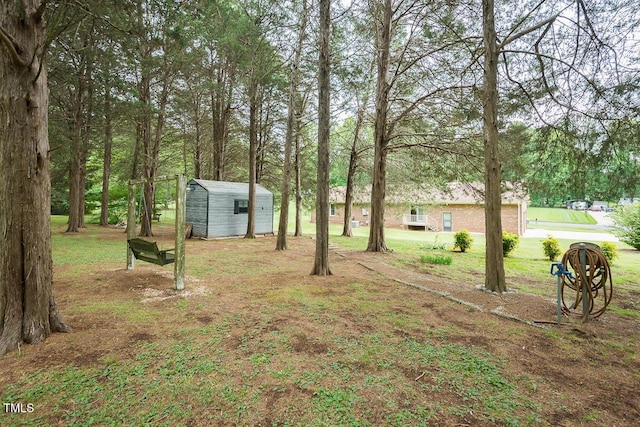 view of yard featuring a storage unit and an outbuilding