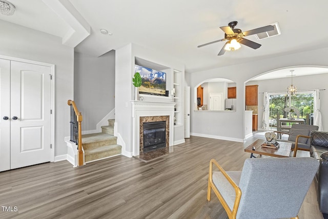 223 Morgan Brook Way, Rolesville, NC 27571 - living room with wood finished floors, ceiling fan, arched walkways, stairs, and baseboards