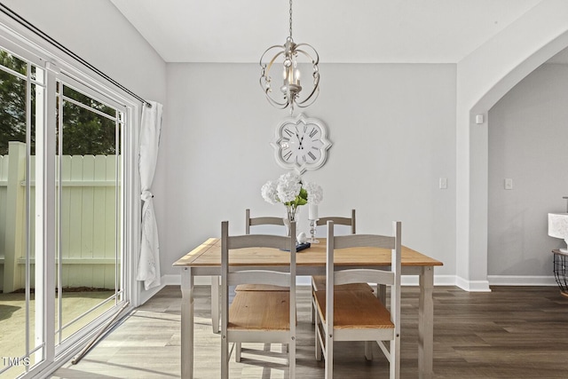 223 Morgan Brook Way, Rolesville, NC 27571 - dining space featuring wood finished floors, arched walkways, a chandelier, and baseboards