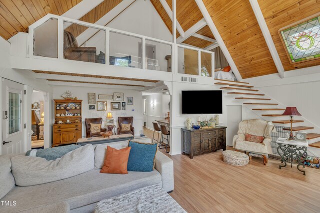 living area with high vaulted ceiling, wood finished floors, beamed ceiling, and wood ceiling