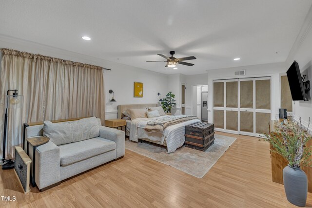 bedroom with light wood finished floors, recessed lighting, and a ceiling fan