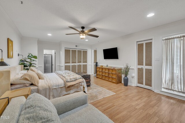 bedroom featuring stainless steel fridge, light wood-style flooring, ornamental molding, recessed lighting, and baseboards