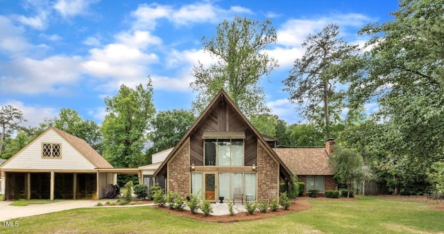 1003 W Divine St, Dunn, NC 28334 - back of house with stone siding, a yard, a chimney, and driveway