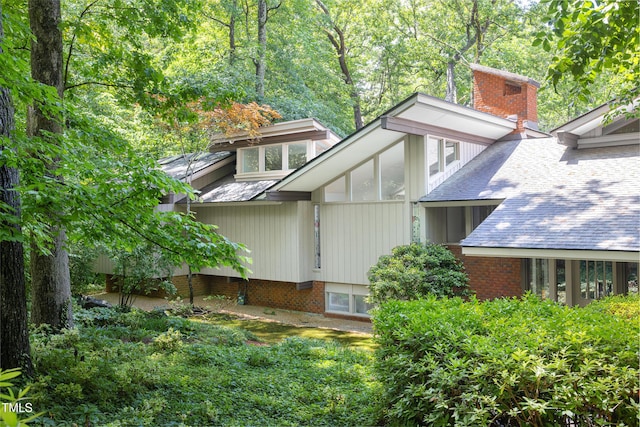 view of property exterior with a chimney
