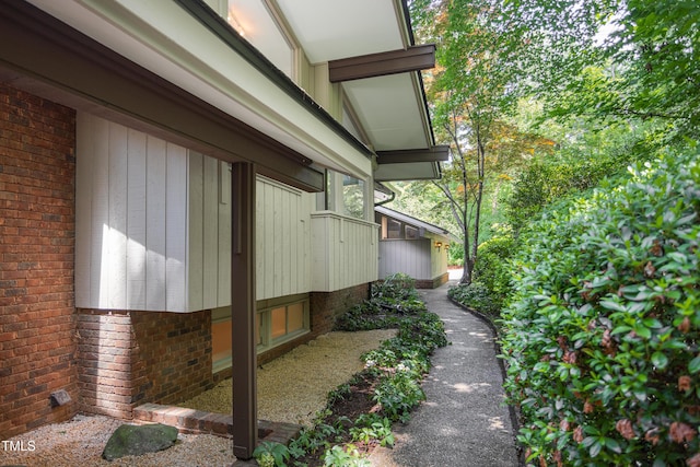 view of side of home featuring brick siding