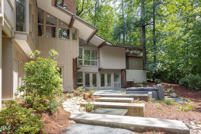 back of property featuring french doors and brick siding