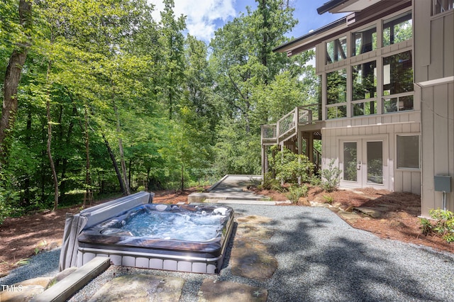 view of yard featuring a covered hot tub, stairway, french doors, and a patio