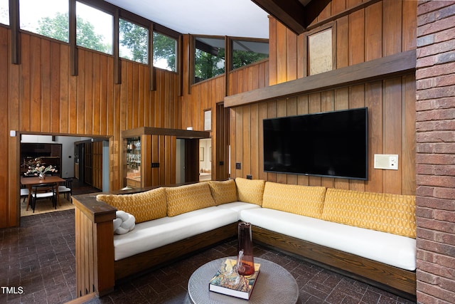 living room with wooden walls and a high ceiling