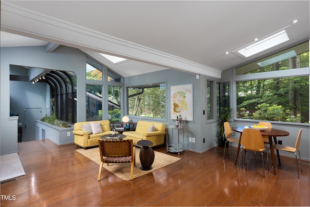 sunroom with a skylight, wood finished floors, and baseboards