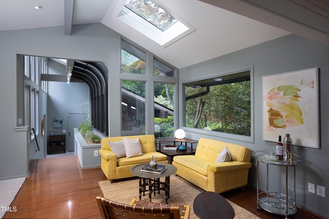 living room with wood finished floors and a skylight