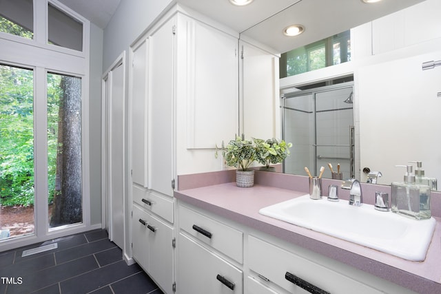 full bath featuring a stall shower, tile patterned floors, vanity, and recessed lighting