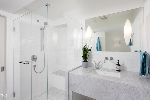 bathroom featuring a stall shower and vanity