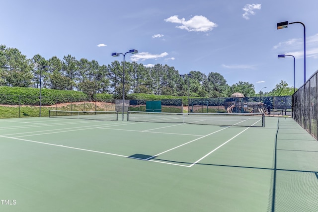 view of tennis court featuring community basketball court and fence