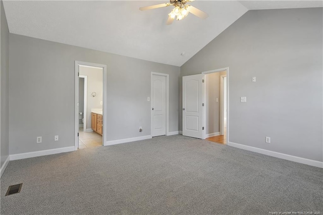 unfurnished bedroom with light carpet, baseboards, ensuite bath, high vaulted ceiling, and ceiling fan