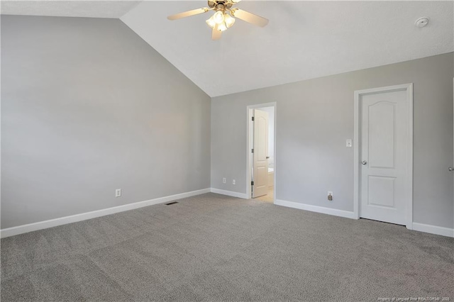 unfurnished bedroom with lofted ceiling, carpet flooring, baseboards, ensuite bathroom, and a ceiling fan