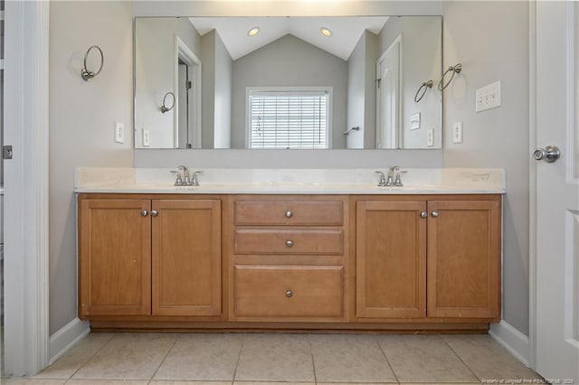 full bath with vaulted ceiling, tile patterned floors, double vanity, and baseboards