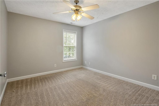 unfurnished room featuring a textured ceiling, baseboards, ceiling fan, and carpet floors