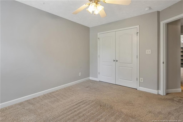 unfurnished bedroom with carpet flooring, baseboards, and a closet