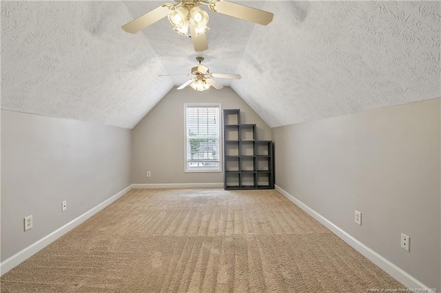 bonus room with a textured ceiling, baseboards, a ceiling fan, carpet, and lofted ceiling