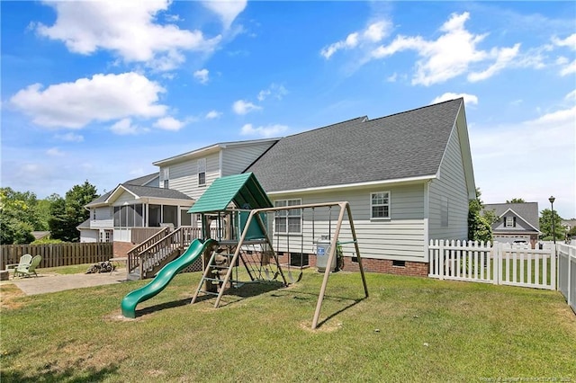 view of playground with a sunroom and a patio
