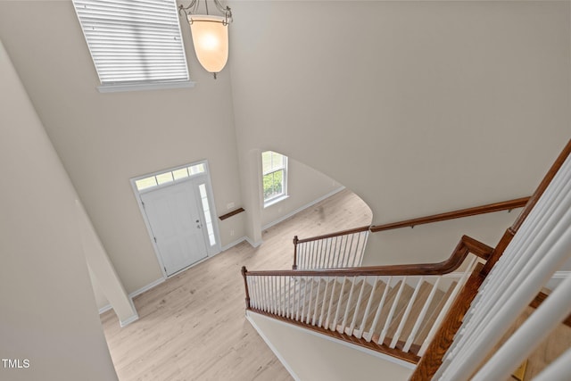 1020 Kingston Grove Dr, Cary, NC 27519 - entrance foyer featuring light wood-type flooring, a towering ceiling, baseboards, and stairway