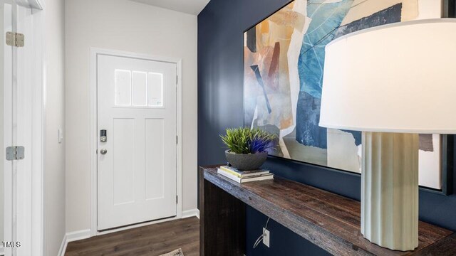 816 Bullhorn Dr, Wake Forest, NC 27587 - entryway featuring dark wood-type flooring and baseboards