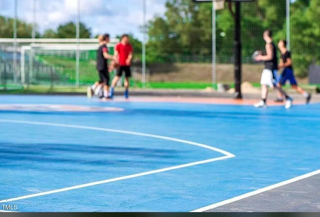view of basketball court with community basketball court, fence, and a sport area