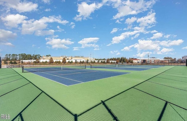 view of tennis court featuring fence
