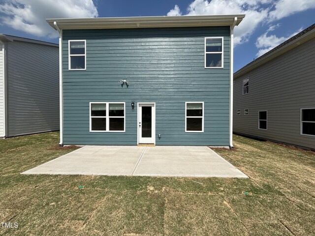rear view of house with a yard and a patio