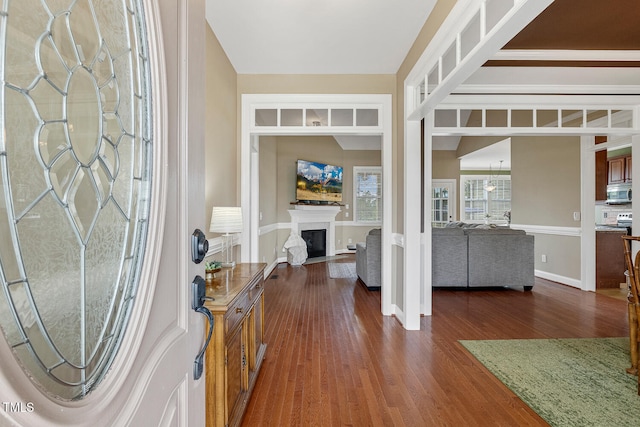 182 Brendamoore Ct, Fuquay Varina, NC 27526 - foyer entrance featuring dark wood finished floors, a fireplace, and baseboards