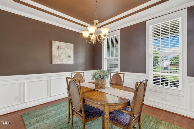 182 Brendamoore Ct, Fuquay Varina, NC 27526 - dining room featuring a chandelier, ornamental molding, wood finished floors, a wainscoted wall, and a decorative wall