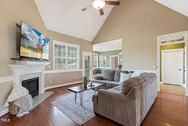 182 Brendamoore Ct, Fuquay Varina, NC 27526 - living room featuring ceiling fan, high vaulted ceiling, wood finished floors, baseboards, and a high end fireplace
