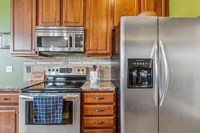 182 Brendamoore Ct, Fuquay Varina, NC 27526 - kitchen with appliances with stainless steel finishes, tasteful backsplash, and brown cabinetry