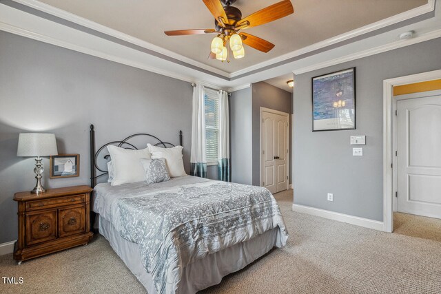 182 Brendamoore Ct, Fuquay Varina, NC 27526 - bedroom featuring light colored carpet, baseboards, ornamental molding, a tray ceiling, and ceiling fan